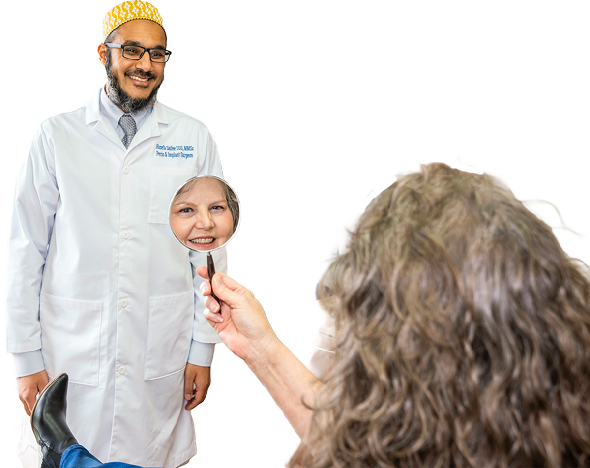 Dr. Saifee looks at a patient checking her smile