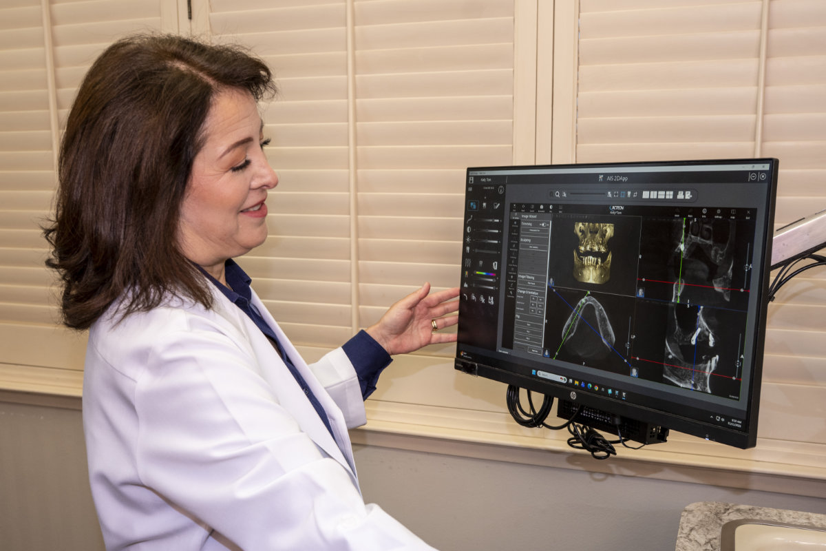 Dr. Sanger using implant planning software on a computer